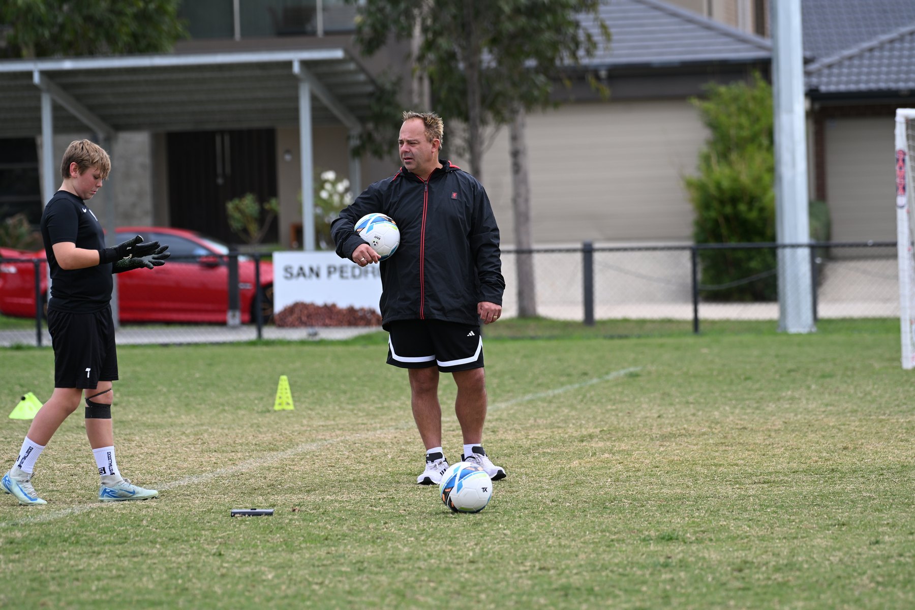 Coach with a keeper at training