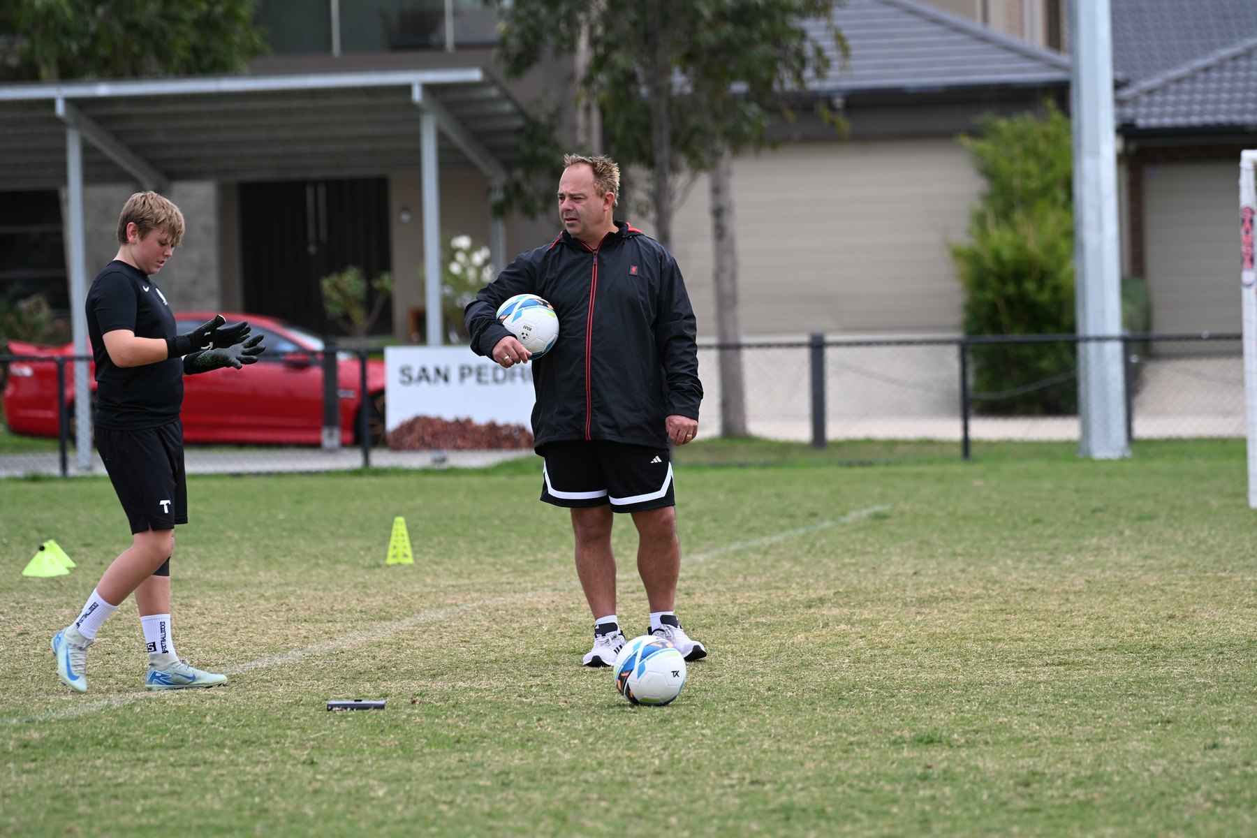Coach instructing keeper