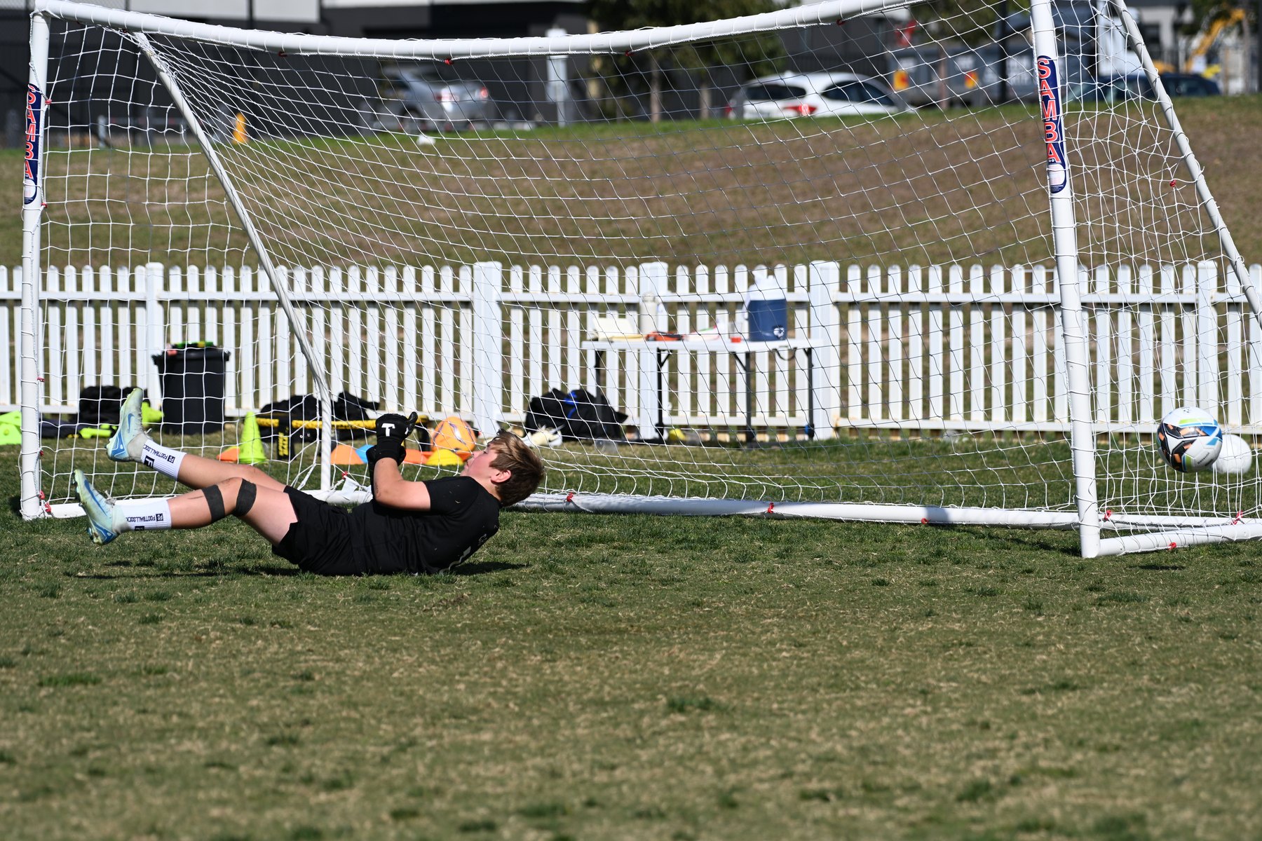 Keeper diving low across the goal